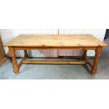 A rectangular pine kitchen table, on turned supports, 82cm wide x 190cm long x 75cm high.