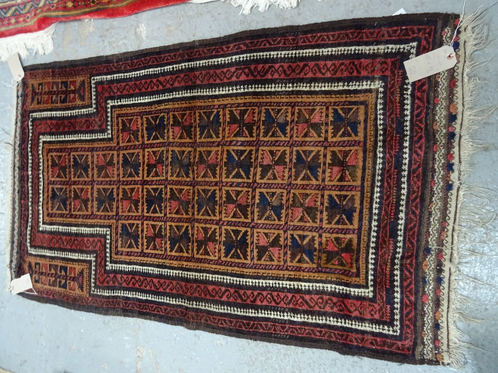 A Beluchistan prayer rug, the pale brown mehrab with squared sections of single flowerheads, - Image 2 of 4