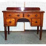 A late Regency mahogany kneehole desk on reeded tapering supports, 102cm wide x 84cm high.