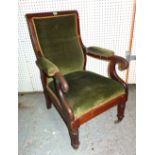 A late Victorian mahogany open armchair with green upholstery.