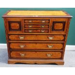A Victorian rosewood banded figured ash chest, with three short drawers flanked by cupboards,