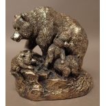 A loaded silver model of a bear with three cubs, in a rocky setting, height 12cm,