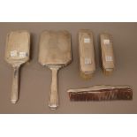 A European five piece part dressing set, comprising; a hand mirror, two differing clothes brushes,