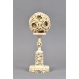 A Chinese ivory puzzle ball and stand, early 20th century,