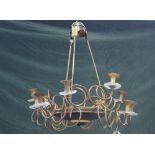 An Empire style gilt and patinated brass twelve branch chandelier,