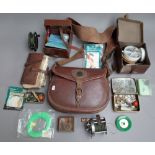 A quantity of fishing related items, including; a leather reel case, a canvas and leather bag, line,