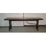 An early 20th century Spanish oak rectangular bench on trestle supports, lacking one metal bracket,