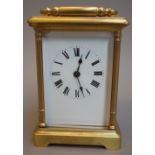 A brass cased carriage clock, 20th century, with visible escapement,