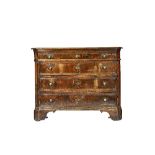A 17th century North Italian walnut commode, with four long graduated drawers,