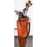 A quantity of 20th century golf clubs contained in a tan leather golf bag.