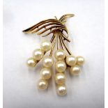 A gold and cultured pearl brooch, designed as a spray, indistinctly detailed 75,
