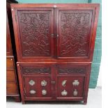 A 19th century Chinese carved camphor double height four door cupboard, with hardstone inset panels,