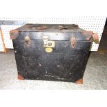 An early 20th century canvas travelling trunk and a quantity of toy train track including some