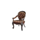 A diminutive Victorian walnut framed spoon back open armchair on floral carved scroll supports,