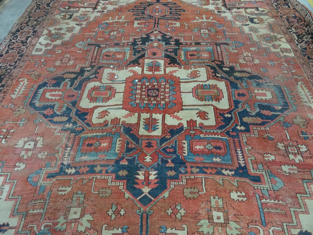 An Heriz carpet, Persian, the madder field with a bold angular pole medallion, ivory spandrels, - Image 4 of 23