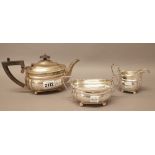 A silver composite three piece tea set, comprising; a teapot,