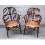 An early 19th century yew and elm bow back Windsor chair on turned supports,