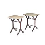 A pair of occasional tables, each with split stone rectangular tops on cast iron trestle bases,