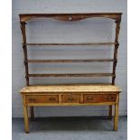An early 19th century pine dresser, the open three tier plate rack over three frieze drawers,