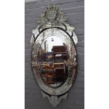 A 20th century cut glass Venetian wall mirror, with foliate shaped crest above oval plate,