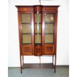 An Edwardian mahogany marquetry inlaid bowfront display cabinet on square tapering supports,