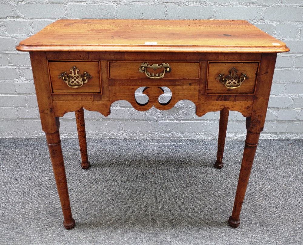 A mid-19th century walnut lowboy with two drawers about the pierced frieze on tapering turned