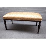 A rectangular footstool, with bow short ends on lappet carved stained oak supports,