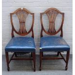 A set of fourteen George III style mahogany shield back dining chairs, on tapering square supports,