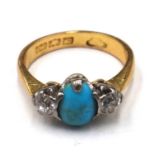 A gold, turquoise and diamond three stone ring, claw set with the oval turquoise,