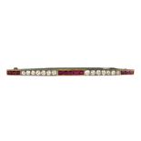 A white gold, diamond and ruby bar brooch,