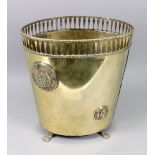 A late 19th/early 20th century brass coal bucket with unusual top rail, on claw feet,