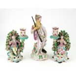 A pair of Derby porcelain figural candlesticks, circa 1770,