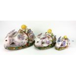 A graduated set of three Italian pottery novelty tureens in the form of rabbits, each with a ladle,