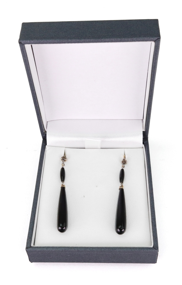A pair of gold, onyx and diamond pendant earrings, each mounted with a double onyx drop,