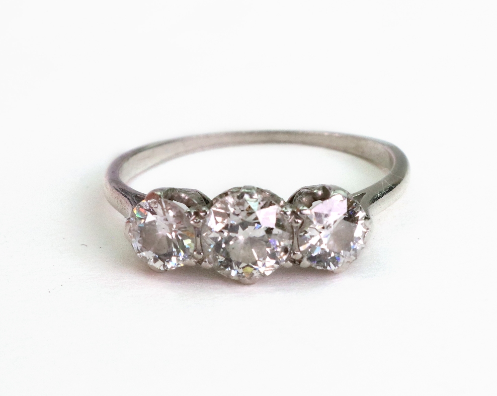 A diamond three stone ring, claw set with circular old cut diamonds, ring size N 1/2, 2.87g gross.