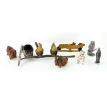 An early 20th century painted lead miniature garden rake upon which two chickens are perched,