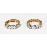 A pair of gold diamond hoop earrings,