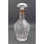 A silver mounted heavy glass decanter, C J Vander, date letter rubbed, with a foliate cut band,