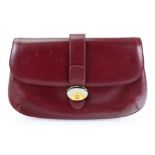 Gucci; A maroon leather clutch purse, wi