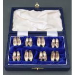 A cased set of eight novelty silver menu