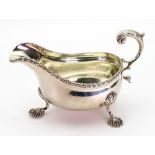 A George III style silver helmet sauce boat, Charles Stuart Harris, London 1904, with gadroon rim,