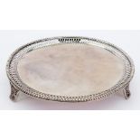 A George III silver circular waiter, John Carter, London 1774, with a pierced border and beaded rim,