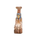 An Egyptian carved wooden funerary figure with polychrome remnants of painted decoration, 31cm high.