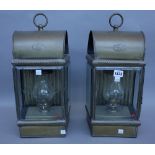 A pair of patinated metal wall mounted oil lamps/lights by Davey & Co, London,