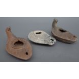 Three Roman style terracotta oil lamps, the largest 12 cm wide, (3).