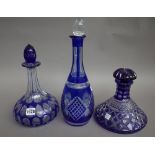 A set of three globe and shaft, hobnail cut decanters, each with lion engraved heraldic crest,