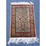 A silk Kayseri rug West Anatolia, stepped mirrored mihrab within pale green spandrels,