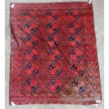 An Afghan Ersari carpet, the madder field with six rows of three bold guls and supporting motifs,