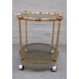 A mid-20th century lacquered brass circular two tier serving trolley, 55cm diameter x 61cm high.