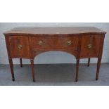 A George III marquetry inlaid mahogany serpentine sideboard with three frieze drawers on tapering